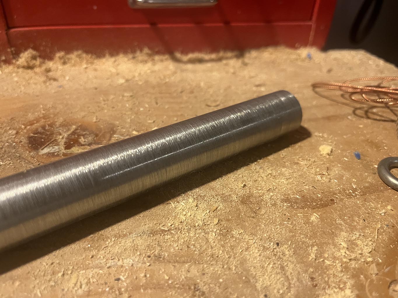 brushed steel pipe on work bench